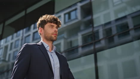man professional walking downtown in suit closeup. confident ceo going street