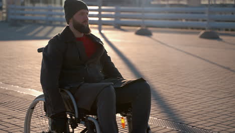 man in wheelchair at sunset