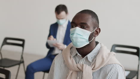 african man in face mask nodding