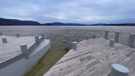 a large wooden dock patio overlooking the hudson river as seen from beacon, new york