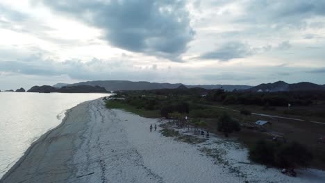 aerial 4k flyover beautiful isolated beach at sunset, lombok indonesia