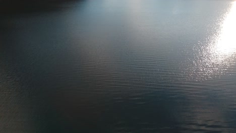 Ascending-aerial-shot-over-the-water-of-the-Endine-lake-in-Italy