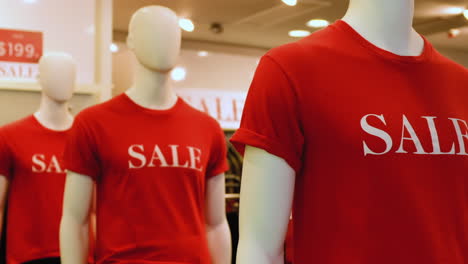 Primer-Plano-De-Maniquíes-En-Camisetas-Rojas-Con-Las-Palabras-Venta-En-Tienda-Minorista