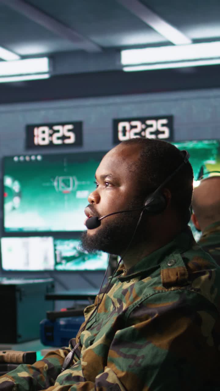 Vertical video Military dispatcher managing communications networks, looking at screens