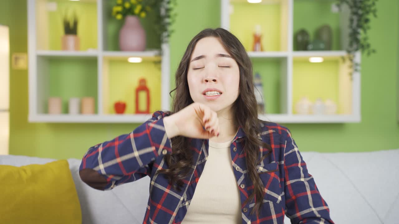 Sleepy Asian young woman yawning.
