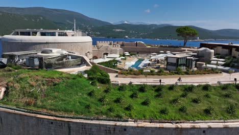 mamula fortress and luxury hotel on mamula island, montenegro. ascending backward drone aerial