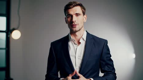 A professional video featuring a confident speaker in a suit, delivering a message in a well-lit