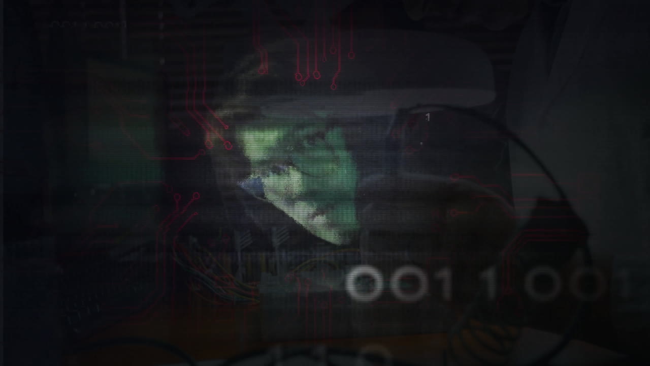 Binary code and circuit animation over person working on computer