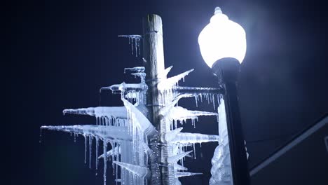 a stunning display of ice: intricate icicles formed on a streetlight during a cold winter night, highlighting nature's artistry and the chill of the season