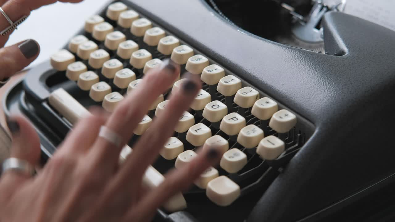 Medium close up woman hands typing on typewriter