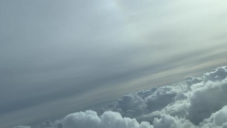 aerial view of some clouds from above taken from a cockpit just before sunset in a winter’s day