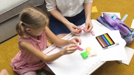 mother and daughter doing arts and crafts at home