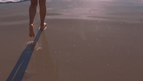 close-up-woman-feet-walking-barefoot-on-beach-at-sunset-enjoying-waves-splashing-gently-female-tourist-on-summer-vacation