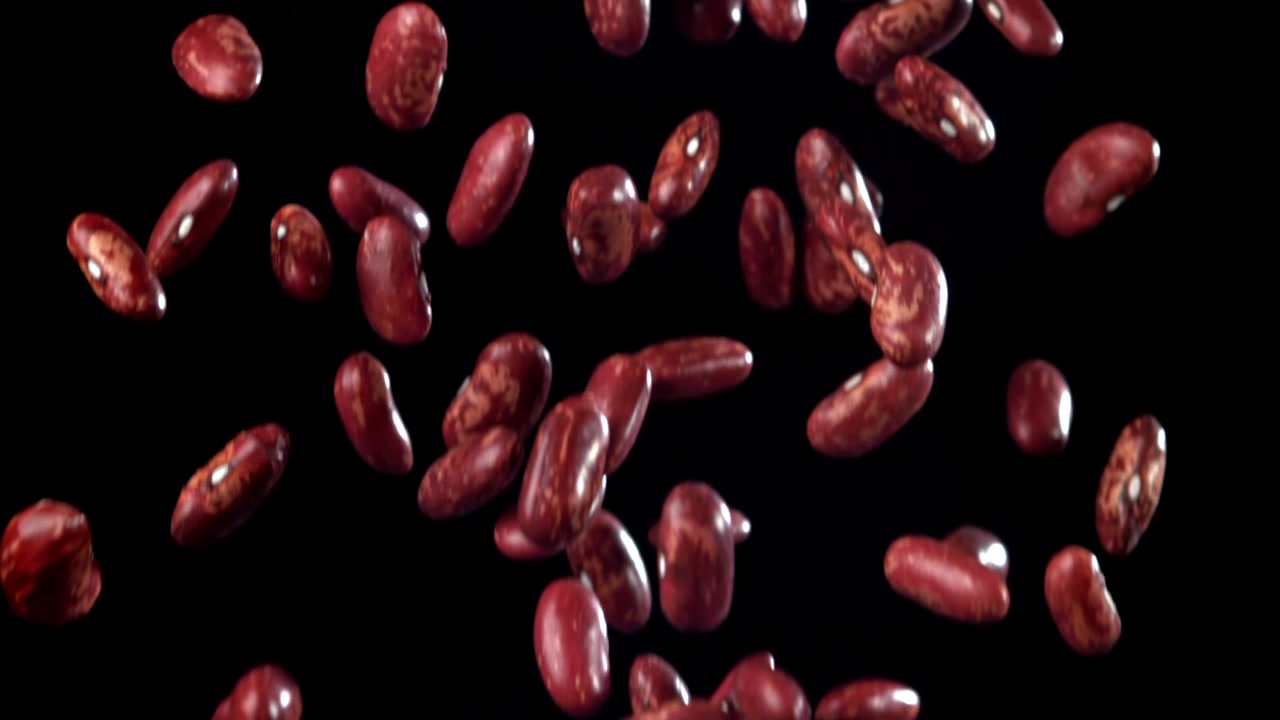 Red Kidney Beans Falling in Slow Motion on Black Background