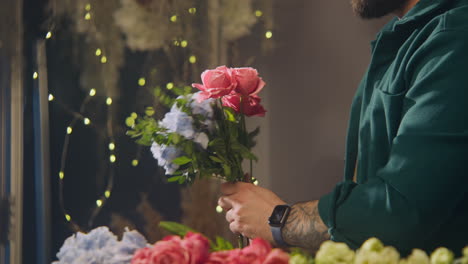 florist prepares beautiful bouquet for sale