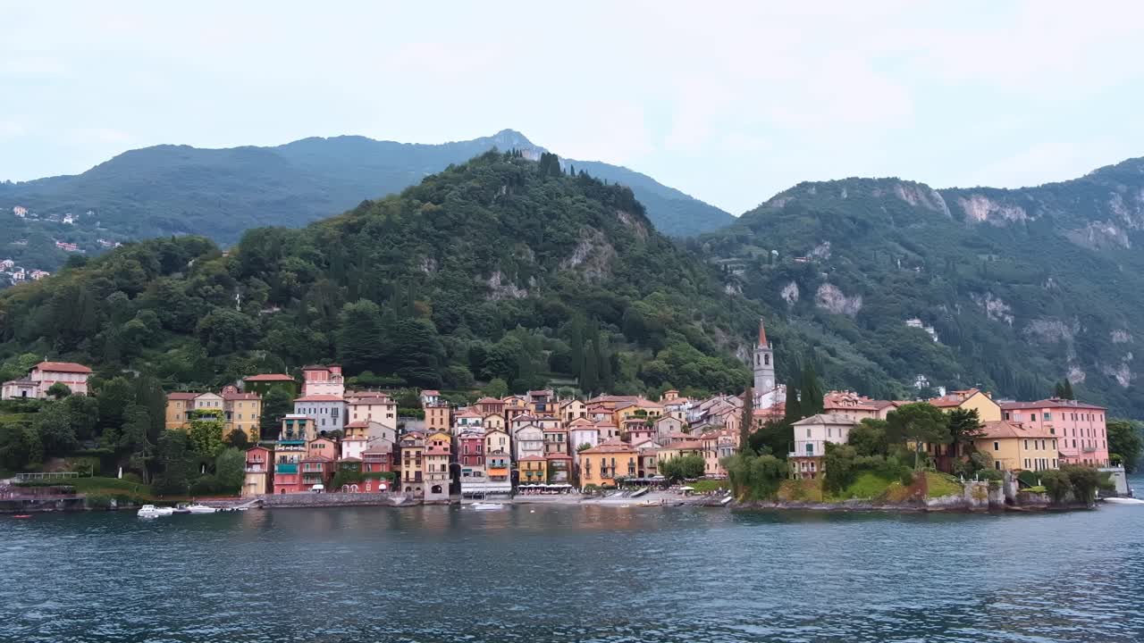 LOMBARDY, ITALY - AUGUST 02, 2018: Cinematic shot of Bellagio town, Como lake and mountains from a boat