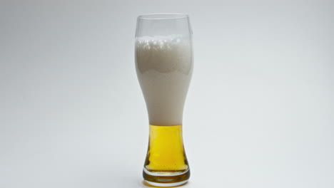 hoppy unfiltered drink foaming slow motion. alcoholic beverage pouring glass