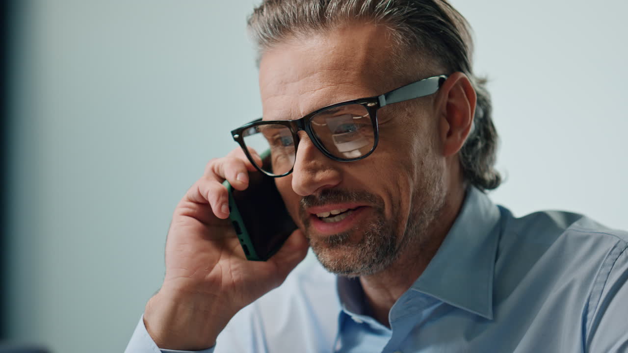 Excited director talking smartphone call at office portrait. Winner saying yes