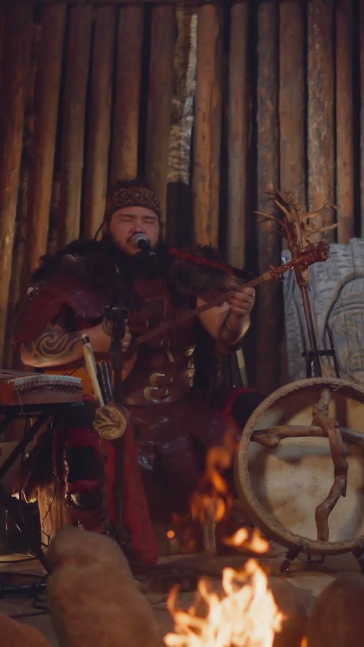 Altai folk ethnic music band performs on stage decorated with rough logs. Men in national clothes play ancient traditional instruments. Atmospheric show