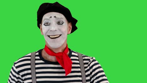 mime artist smile and simulate walking on a green screen, chroma key