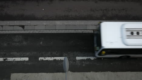 aerial top down shot of bus and cyclist crossing the street,real time