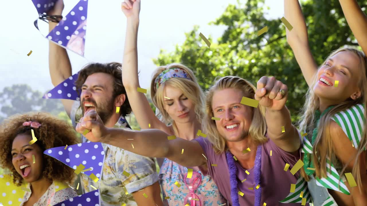 Friends standing in park, raising arms and pointing, causing gold confetti shower for event promo