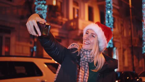 young beautiful girl at christmas to walk around city and take selfie. lights