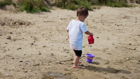 toddler playing in the sand