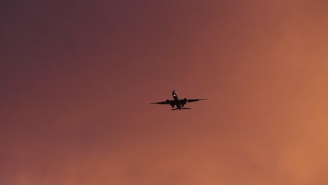 silhouette plane flying in dramatic sky - low angle shot