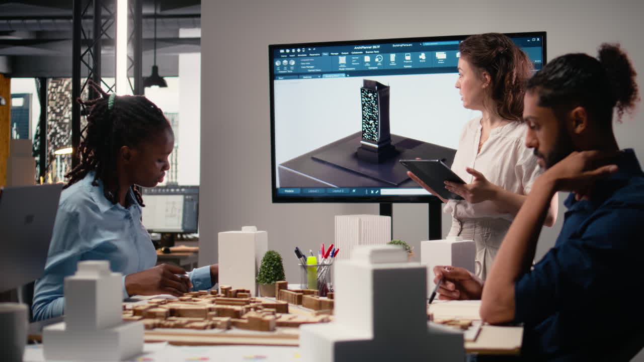 Female real estate contractor presenting structural blueprints and 3D models