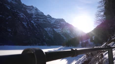 beautiful wide angel shot of a frozen mountain lake in the klöntal, switzerland