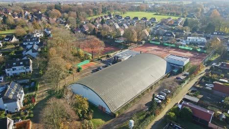 Aerial-of-an-empty-tennis-court-in-small-town-on-a-sunny-autumn-day