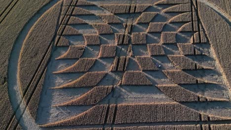 aerial of intricate patterns carved in the farm field of micheldever station during a crop circle exhibition in england, uk