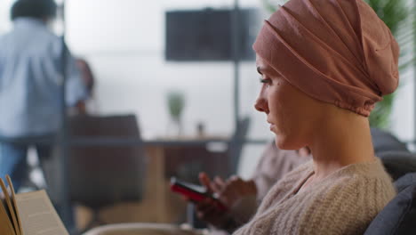 Close-Up-Of-Young-Woman-Patient-Wearing-Headscarf-Undergoing-Chemotherapy-Treatment-For-Breast-Cancer-In-Hospital-Clinic