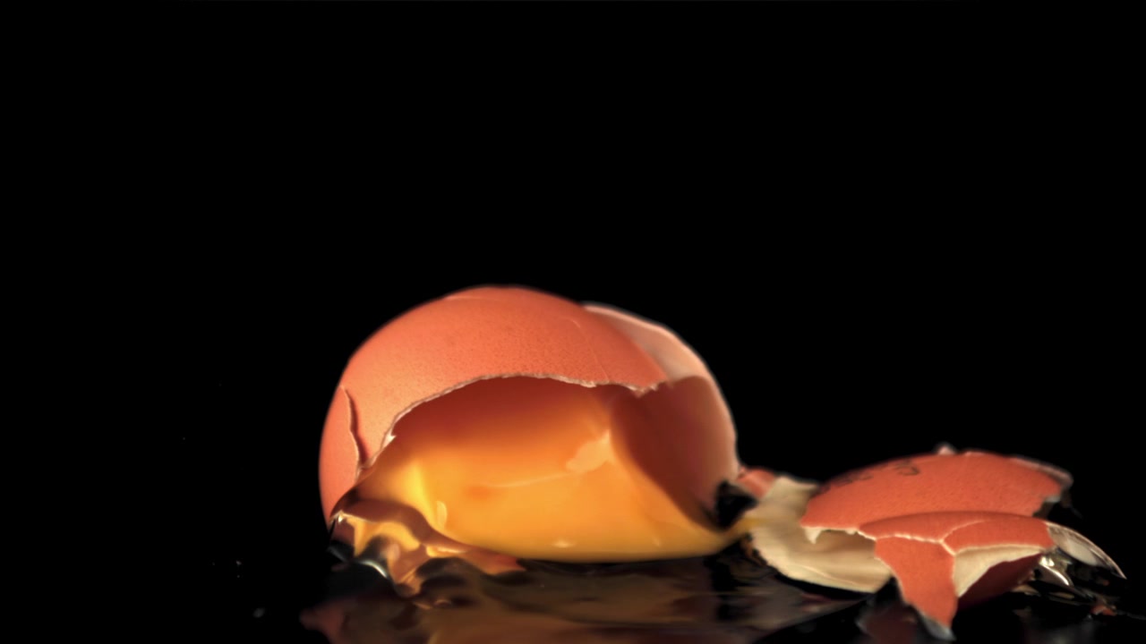 Slow Motion Shot of a Brown Egg Falling and Breaking