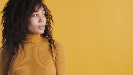 African-american-smiling-woman-over-orange-background.