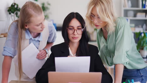 female employees discuss strategy with team leader