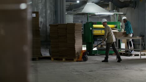 factory workers handling cardboard boxes