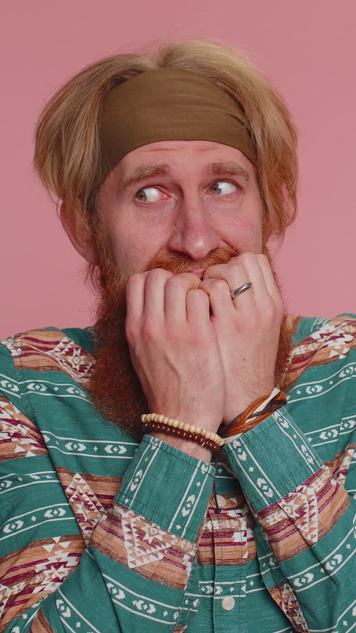 Scared frightened hippie man biting nails feeling worried nervous about serious troubles stress