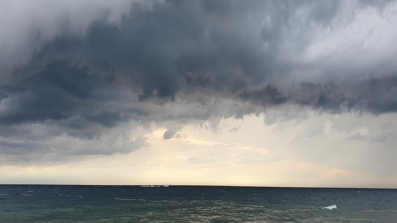 Static shot of incoming grey cyclones with rough seas at the coast