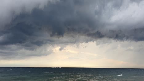 static shot of incoming grey cyclones with rough seas at the coast