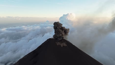 volcano of fuego emits black smoke and lava with power, aerial view