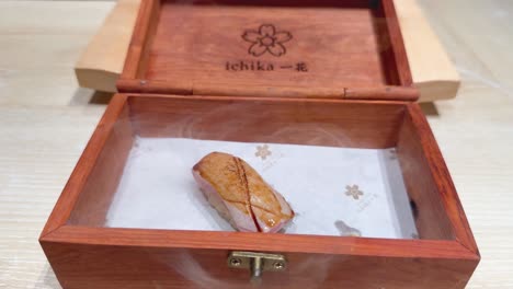 sushi served in a steaming wooden box