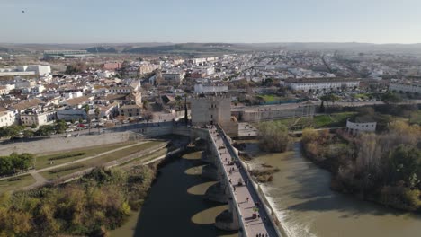 aerial view of historic center of cordoba with ancient roman bridge over guadalquivir river in spain