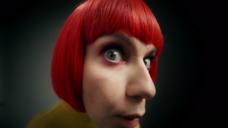 close-up portrait of a woman with red wig and exaggerated expression