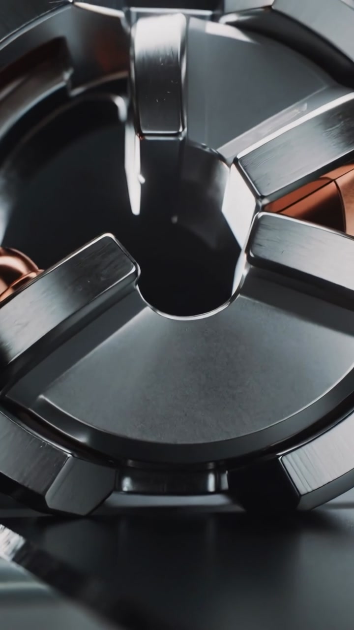 Vertical video: Rotating segmented ring, motor engaging on studio tabletop, revealing copper core