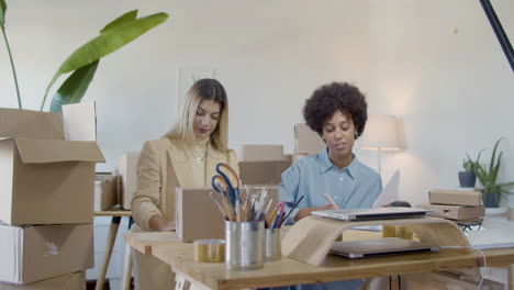 two female entrepreneurs working in office and cheering