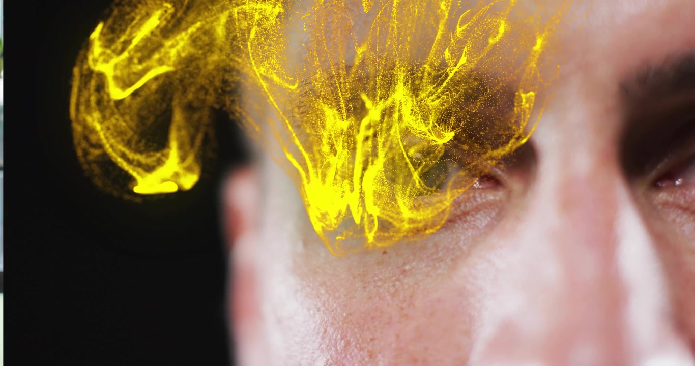 adult male eye focusing as gold particles starting cascading across eyelid creating tech effect