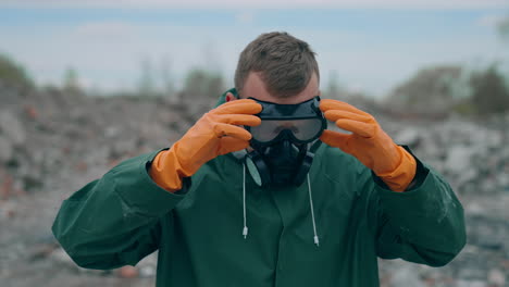 apocalypse man with gas mask in ruins. portrait of man in the gas masks and protective clothes on the ruined background