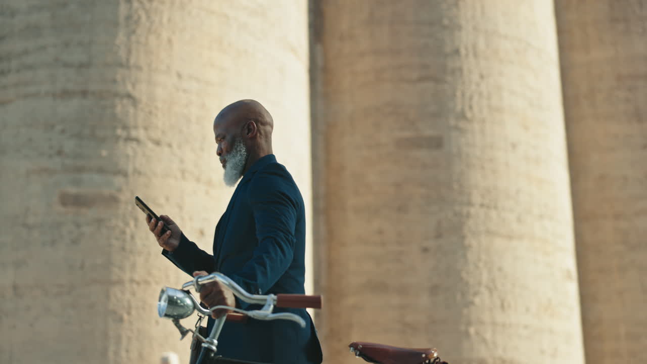 hombre de negocios urbano caminando con el teléfono